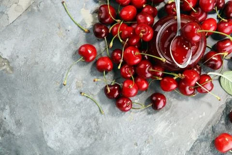 Rustic jar with cherry jam and fresh cherries, homemade preserves Stock Photos