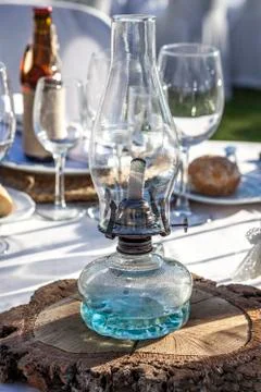 Rustic kerosene lamp over log cut as a wedding centerpiece table Stock Photos