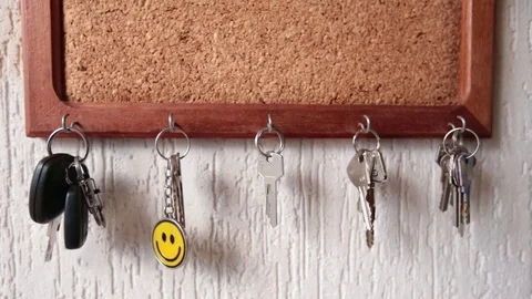 Rustic Key Holder, cork board. A person takes the key. Stock Footage 73673031