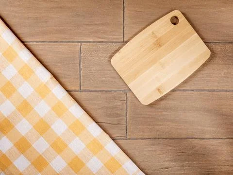Rustic Kitchen Background with Checkered Napkin and Cutting Board on Wooden Stock Photos