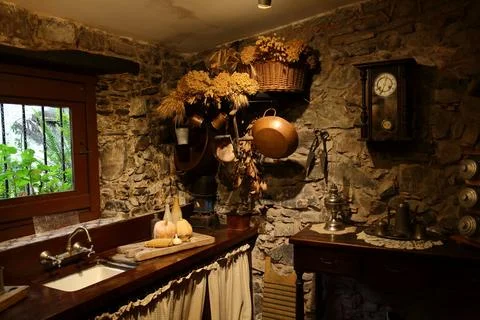 Rustic Kitchen Corner with Stone Walls and Antique Household Items Photos