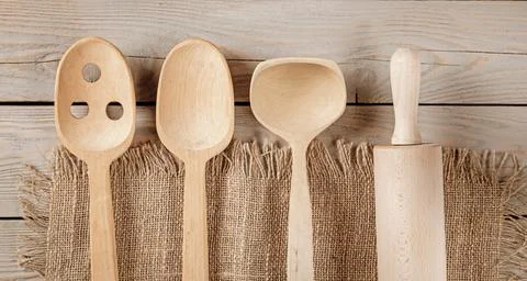 Rustic Kitchen Decor: Wooden Accessories and Towel on Natural Board Background Stock Photos