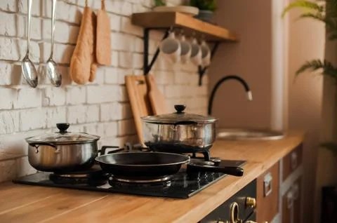  Rustic kitchen details. Empty pans and pans in the kitchen close-up and copy sp Stock Photos