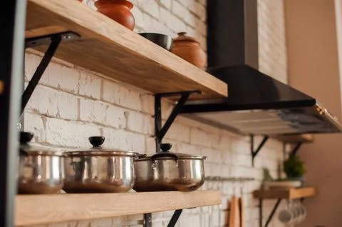  Rustic kitchen details. Empty pans and pans in the kitchen close-up and copy sp Stock Photos
