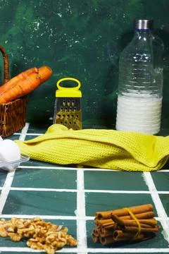 Rustic Kitchen Ingredients Still Life With Carrots, Milk, Eggs, Walnuts and Cinn Stock Photos