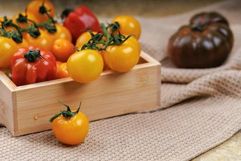 Rustic kitchen scene with cherry tomatoes in box Stock Photos
