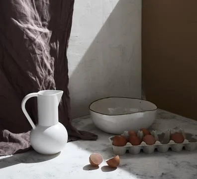 Rustic Kitchen Scene with Eggs, Bowl, and Ceramic Pitcher Stock Photos