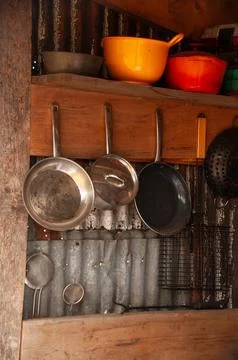 Rustic Kitchen Shelf With Hanging Pots, Pans and Vintage Cookware Stock Photos
