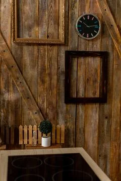 Rustic Kitchen Wall Decor Featuring a Classy Clock Alongside Stylish Frames for Stock Photos