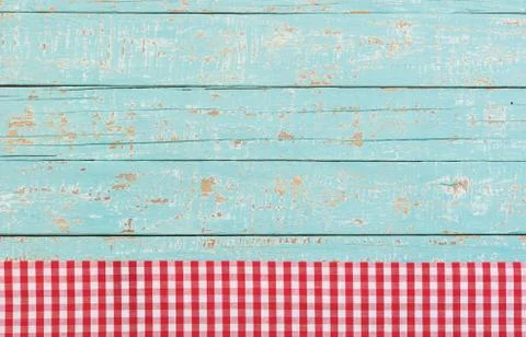 Rustic kitchen wood table background with red checked tablecloth Stock Photos