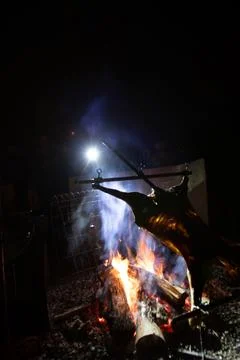 Rustic lamb barbecue bbq over open fire in Chile Stock Photos