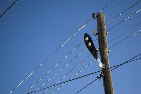 Rustic lamppost with wires, rustic lighting. Stock Photos