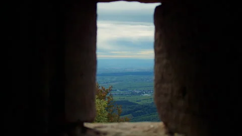 Rustic landscape with mountains as seen through the crack in the wall. Video stock 311886693