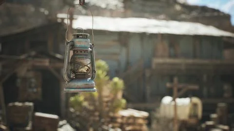 Rustic lantern hanging in front of an old building in a deserted area Ilustración de archivo