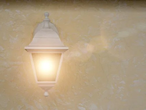 Rustic light is lighting on on the concrete wall. Light is switched On. Textured Stock Photos