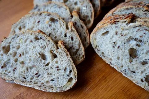 Rustic loaf and sliced bread on table Stock Photos