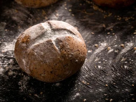 The rustic loaf of bread placed on wooden black background Foto stock