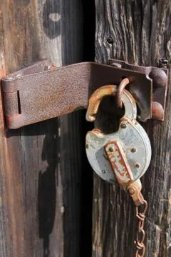 Rustic lock on latch of old outdoor country structure. Stock Photos