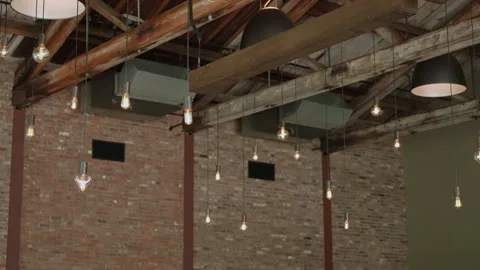 Rustic Loft Ceiling Features Exposed Bricks And Vintage Edison Fixtures Casting Stock Footage 323770770