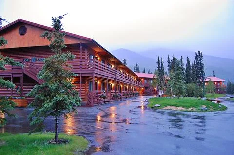 A rustic log cabin with lodge displayed, suggesting warmth Stock Photos