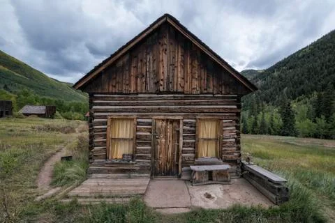 Rustic log cabin in valley Stock Photos