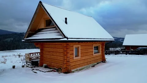 Rustic Log Home in Snowy Mountains with Zoom Effect Stock Footage 327482003