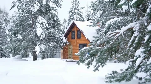 Rustic log house, snowy pine trees, big snowdrifts, slowly snowing. Stock Footage 168380188