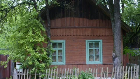 Rustic log house with windows with carved platbands in the background of sk.. Stock Footage 277491829