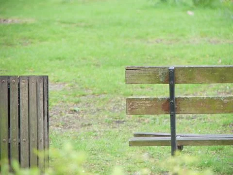 A rustic looking park bench and bin, in Paddington Green, London, England Stock Photos