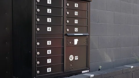 Rustic mail boxes wall in front of a building 4k Stock Footage 124448705