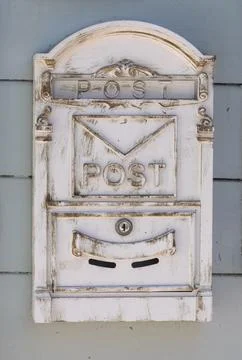 Rustic mailbox mounted on a wall with a classic design featuring the word p.. Stock Photos
