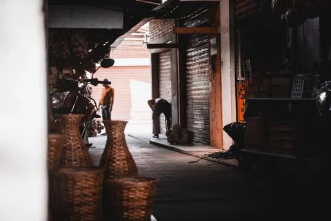 Rustic Market Scene with Wicker Baskets and Worker Stock Photos
