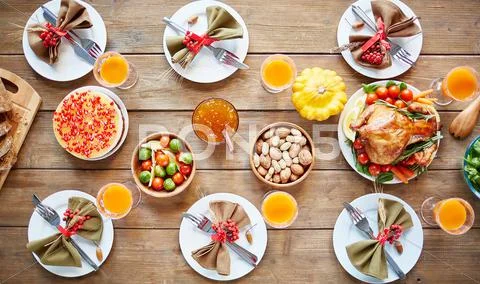 Rustic meal with vegetables, roasted chicken, homemade dessert on a nicely settl Stock Photos