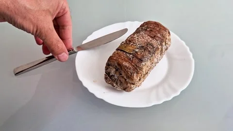 Rustic Meatloaf on White Plate with Knife Ready for Serving Stock Footage 337286313