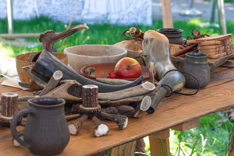Rustic medieval feast table with antlers and drinking horns Фото