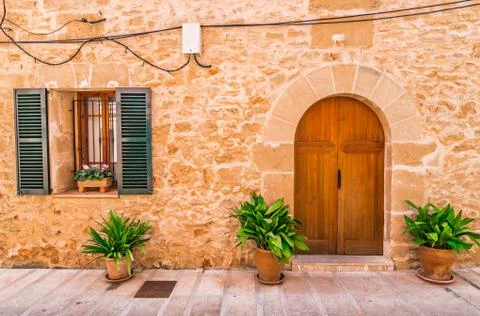 Rustic mediterranean house window with open shutter and front door entrance Stock Photos