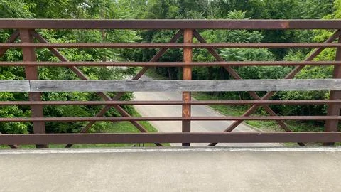 Rustic Metal Railing Overlooking Forest Path Stock Photos