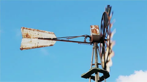 Rustic Metal Windmill Rotating Against Blue Sky, Rural Agriculture Water Pump 4K Stock-Footage 329733011