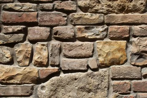 Rustic Mixed Medieval Stone, Brick Wall Texture with Earth-Tone Masonry Pattern Stock Photos