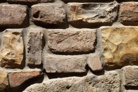 Rustic Mixed Medieval Stone, Brick Wall Texture with Earth-Tone Masonry Pattern Stock Photos