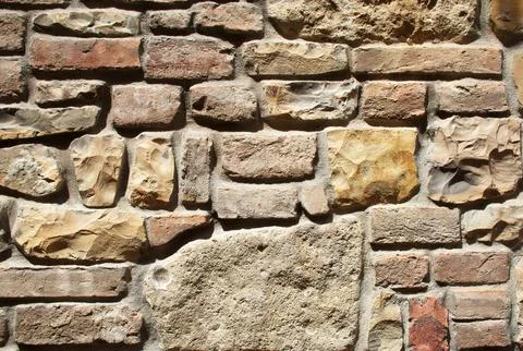 Rustic Mixed Medieval Stone, Brick Wall Texture with Earth-Tone Masonry Pattern Stock Photos