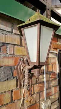 Rustic mossy lamp on brick wall Stock Photos