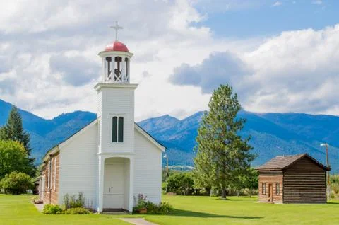 Rustic mountain chapel with cabin Stock Photos