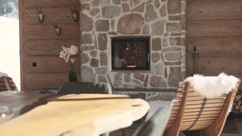 Rustic mountain lodge interior featuring a warm fireplace, wooden furniture, and Vidéo 335198948