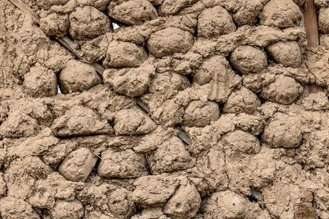 Rustic mud and stick balls wall in rural outdoor setting Stock Photos