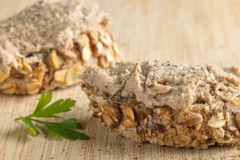 Rustic multigrain bread slice topped with fish spread. Stock Photos