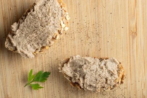Rustic multigrain bread slice topped with fish spread. Stock Photos