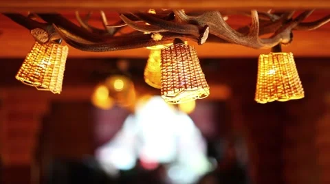 Rustic natural restaurant lamp with deer antler and blurry background Stock Footage 44413322
