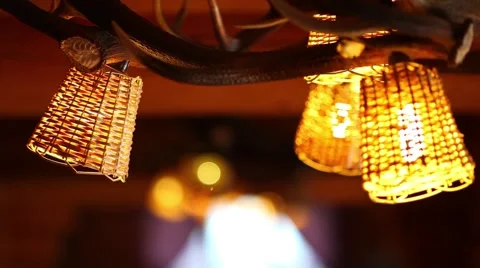 Rustic natural restaurant lamp with deer antler and blurry background Stock Footage 44413345