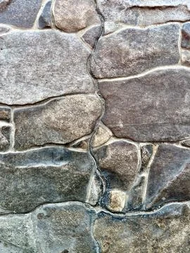 Rustic Natural Stone Wall Background with Varying Shapes and Earthy Tones Stock Photos